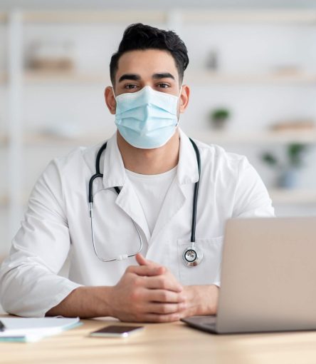 doctor-in-face-mask-working-on-laptop-2021-09-02-17-15-33-utc.jpg